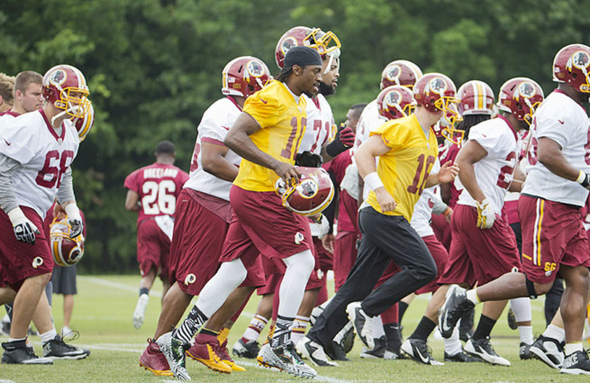 Robert Griffin III (center) has looked strong in offseason workouts after a serious knee injury loomed over his 2013 campaign.