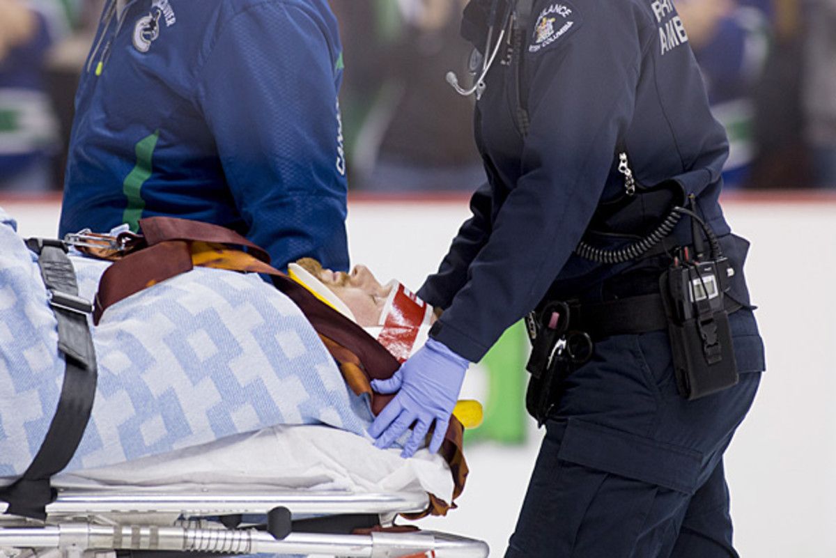 Daniel Sedin of the Vancouver Canucks leaves the ice on a stretcher.