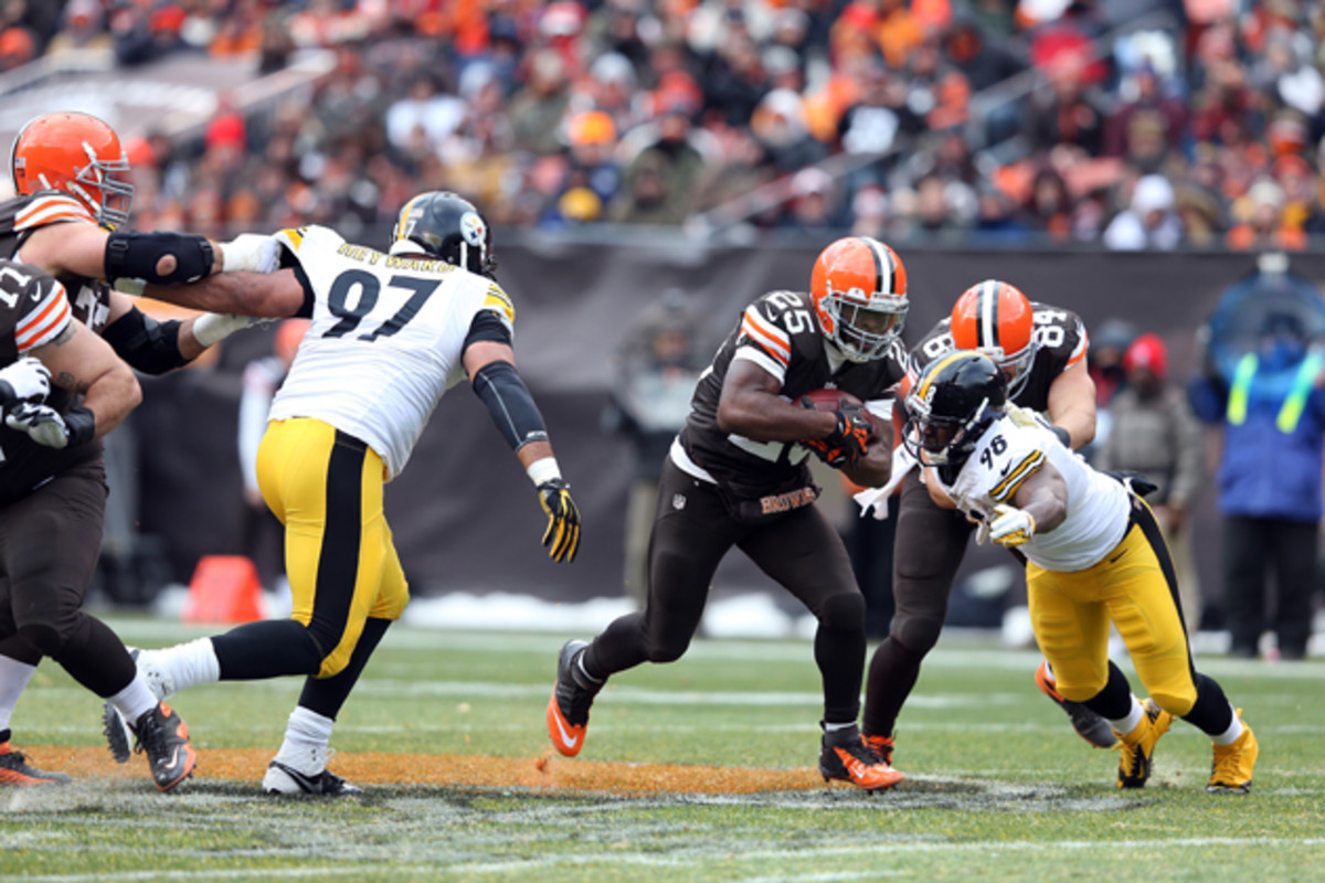 Cleveland Browns running back Chris Ogbonnaya (25) runs for a first down while being chased by Pittsburgh Steelers defensive end Cameron Heyward (97) during a game against the Pittsburgh Steelers on Sunday, Nov. 24, 2013 in Cleveland.