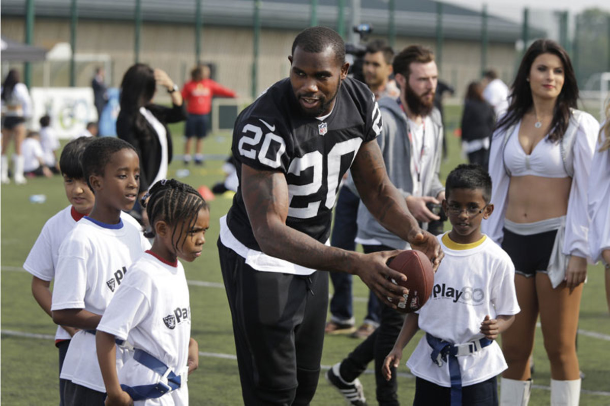 Darren McFadden at a Play 60 event in Surrey. The U.K. fan base is much younger than that in the U.S. (Lefteris Pitarakis/AP)