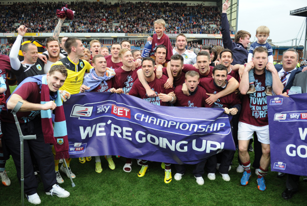 Burnley celebrates its promotion to the Premier League after topping Wigan on Monday.
