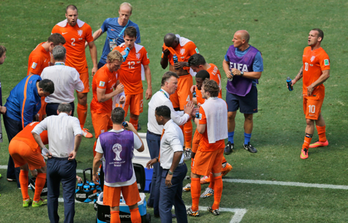 Dutch players consume drinks during a cooling break in the World Cup round of 16 soccer match between the Netherlands and Mexico at the Arena Castelao in Fortaleza, Brazil, Sunday, June 29, 2014.
