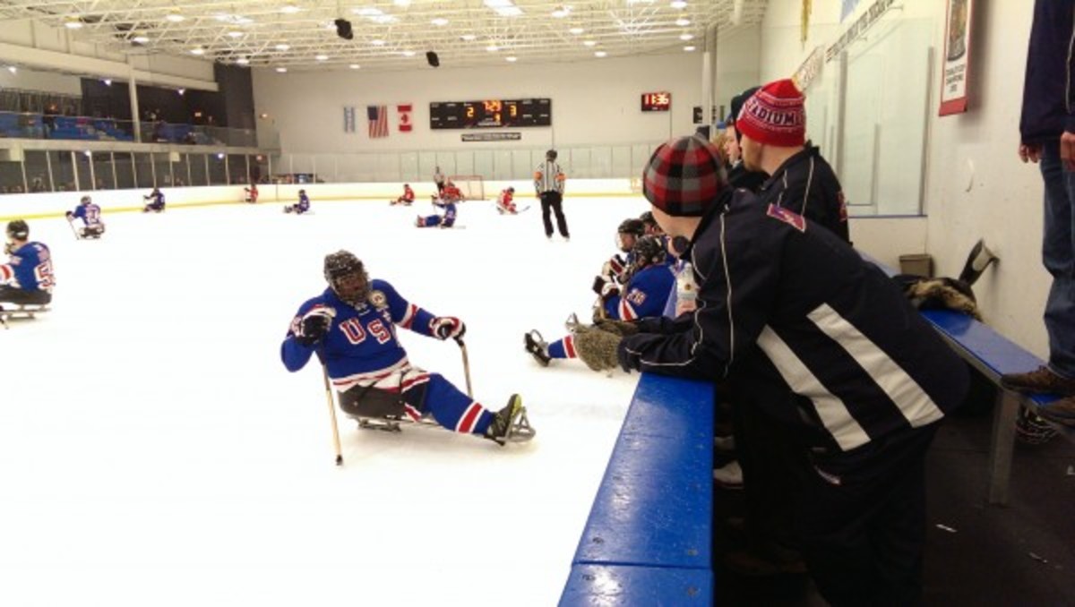 Standing team watching the sled guys