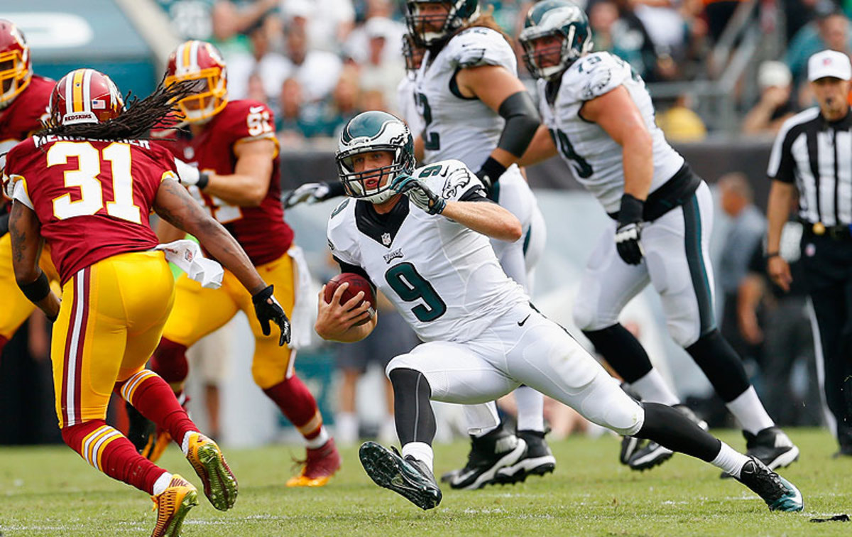 Nick Foles was in harm's way frequently Sunday, but bounced back each time and ultimately led the Eagles to victory. (Rick Schultz/Getty Images)