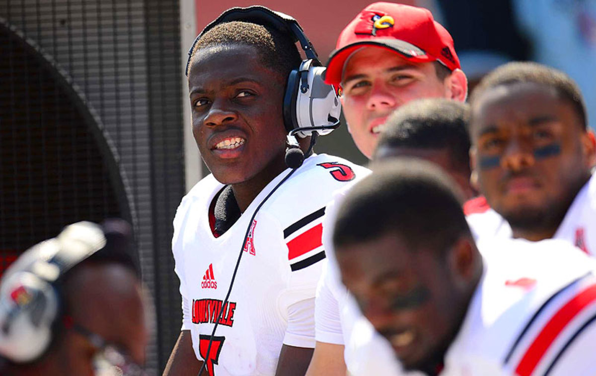 After every series, Bridgewater puts on a headset to go over each play with the offensive coordinator, who watches from the coaches box. (Al Tielemans/SI)
