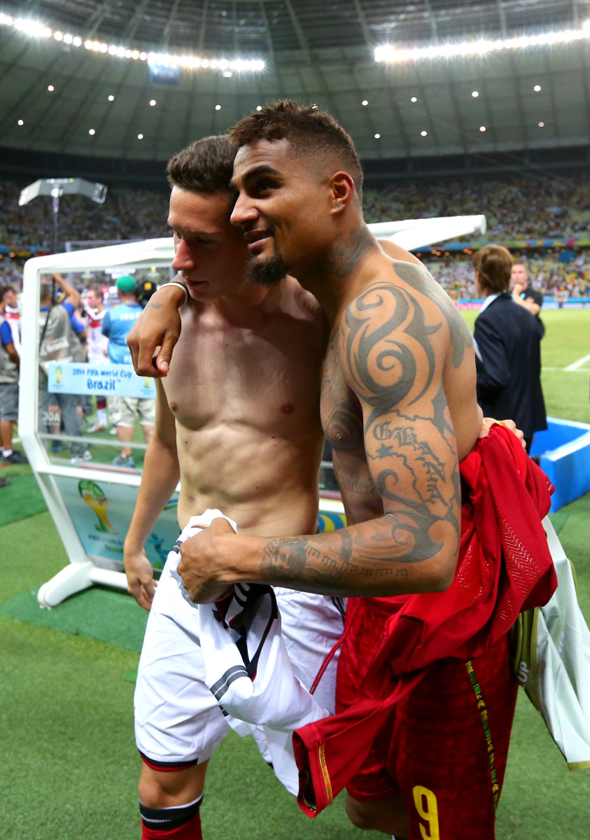 Julian Draxler of Germany and Kevin-Prince Boateng of Ghana speak as they walk off the pitch after the 2-2 draw in the 2014 FIFA World Cup Brazil Group G match between Germany and Ghana