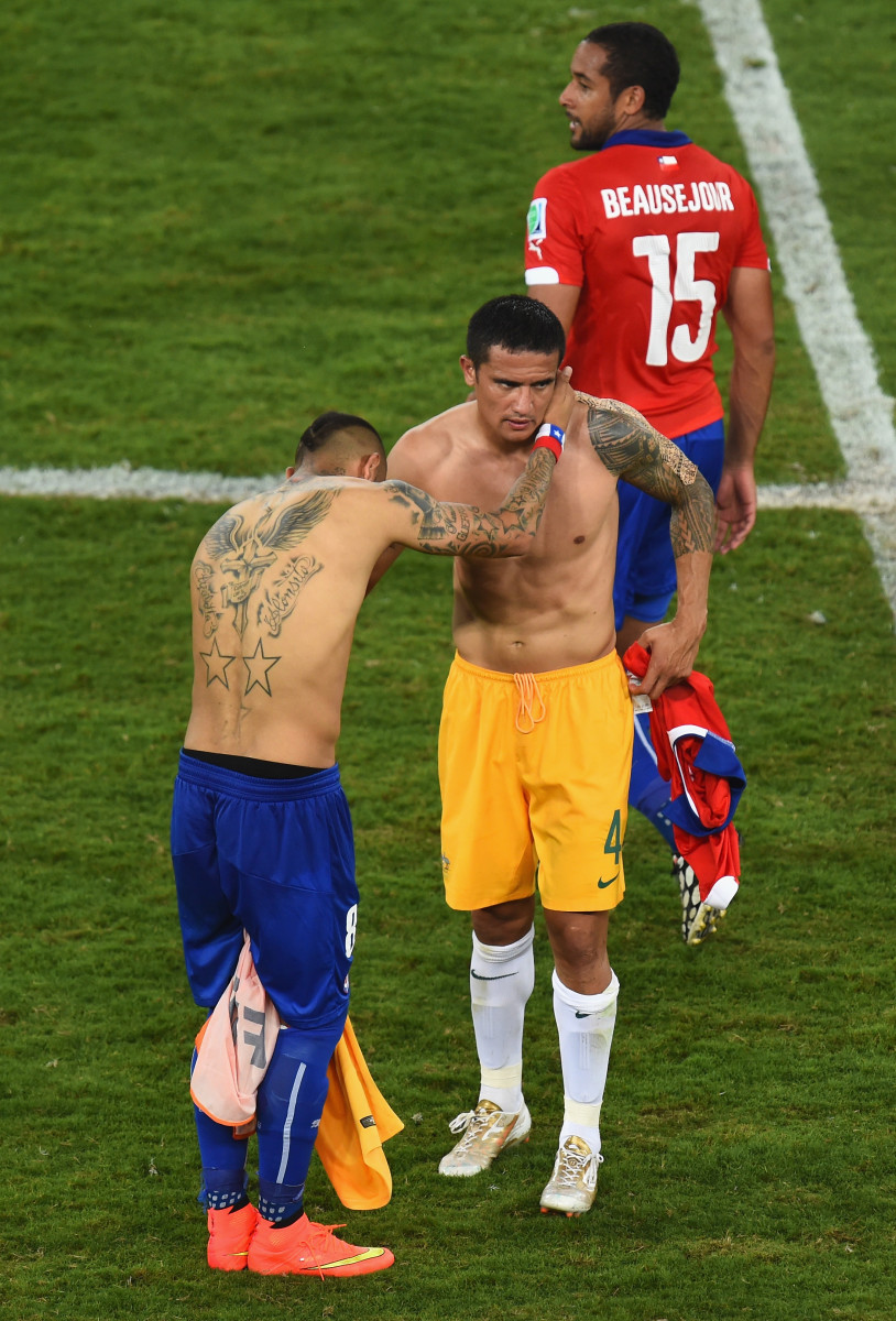Arturo Vidal of Chile (L) and Tim Cahill of Australia swap jerseys after the 2014 FIFA World Cup Brazil Group B match between Chile and Australia at Arena Pantanal 