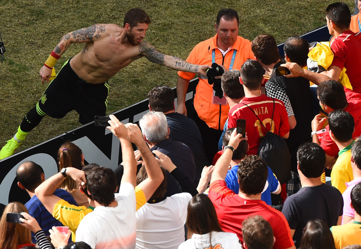 Sergio Ramos of Spain hands his jersey to a fan in the crowd after defeating Australia 3-0 during the 2014 FIFA World Cup Brazil Group B match between Australia and Spain