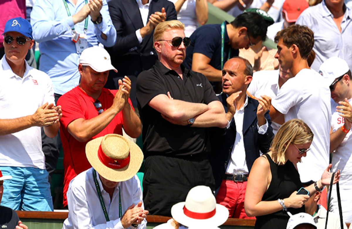 Boris Becker acknowledges Novak Djokovic's first-set victory. (Clive Brunskill/Getty Images)