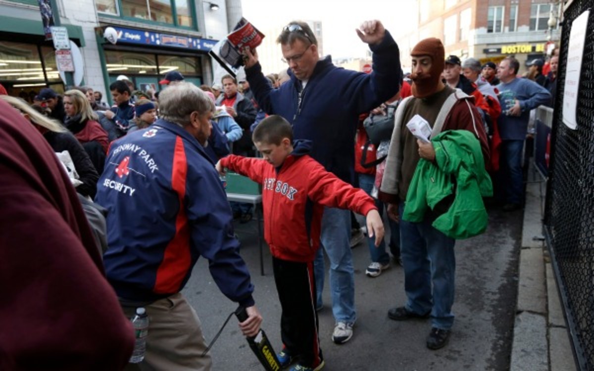 Being scanned at entrances to MLB stadiums will be the norm starting in 2015. (AP Photo/Steven Senne)