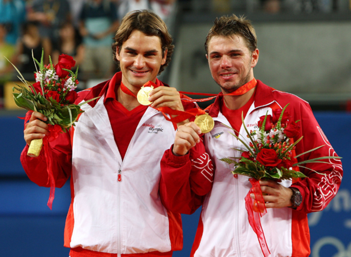 Federer and Wawrinka receive their gold medals after the men's doubles final match.