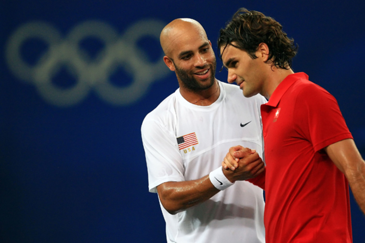 Blake shakes hands with Federer after his win in the men's tennis quarterfinals.