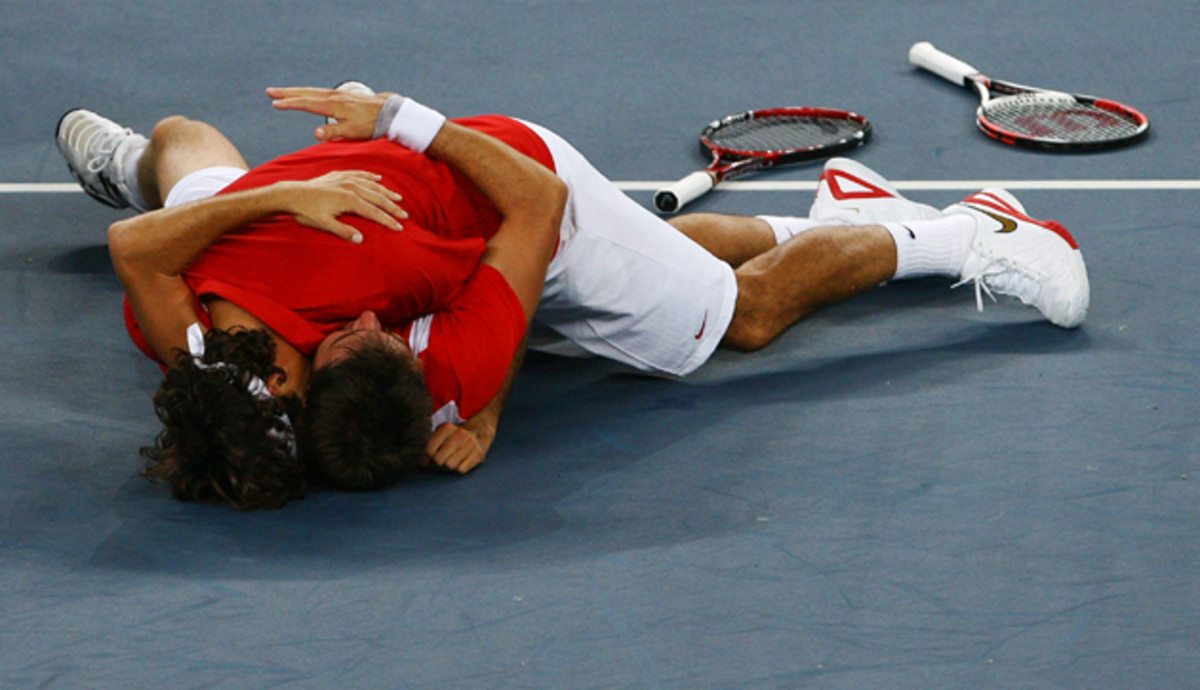 Federer and Wawrinka celebrate after defeating Thomas Johansson and Simon Aspelin of Sweden during the men's doubles gold medal match.