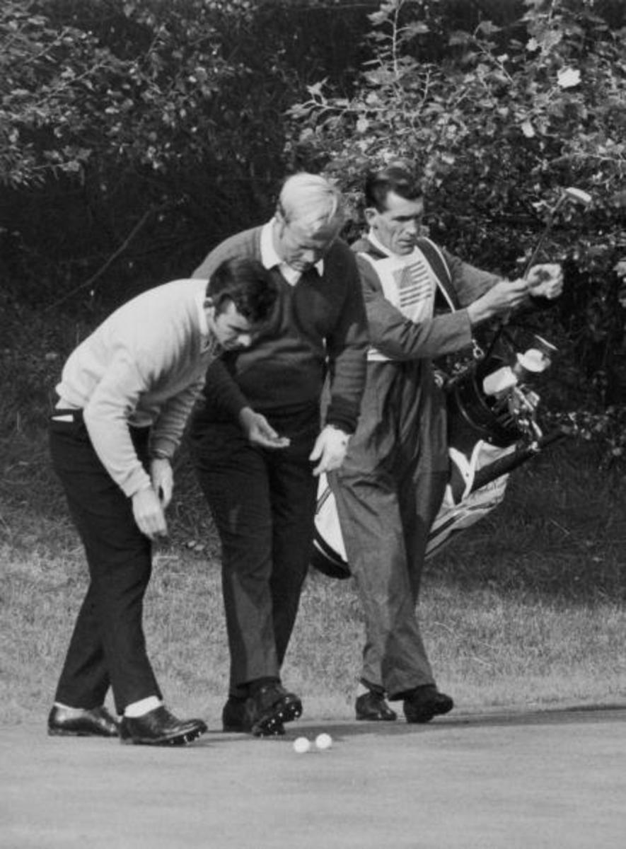 Golfing rivals Tony Jacklin (left) of Britain and Jack Nicklaus of the USA marking their balls after they had played their shot within inches of each other during the Ryder Cup at Royal Birkdale, Lancashire