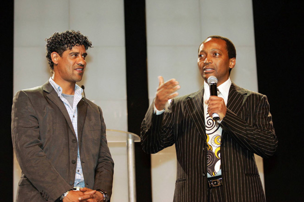 Mamelodi Sundowns current owner Patrice Motsepe talks next to former FC Barcelona manager Frank Rijkaard prior to a friendly between the two clubs in South Africa in 2007.