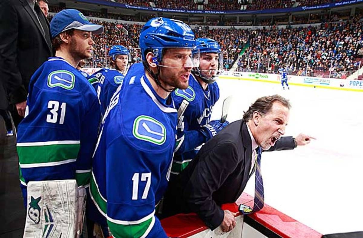 Coach John Tortorella of the Vancouver Canucks screams at Calgary Flames coach Bob Hartley.