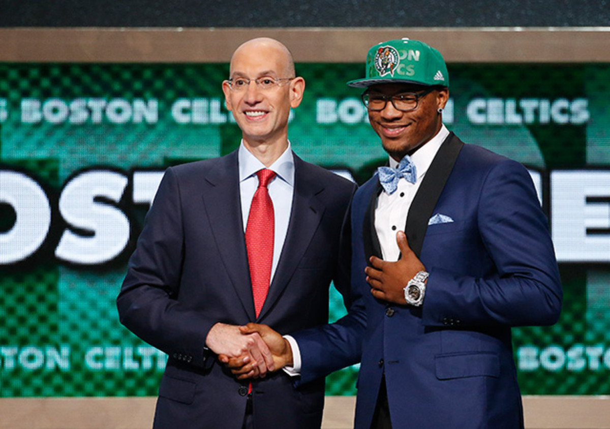 Oklahoma State's Marcus Smart, right, poses for a photo with NBA commissioner Adam Silver after being selected sixth overall by the Boston Celtics during the 2014 NBA draft.
