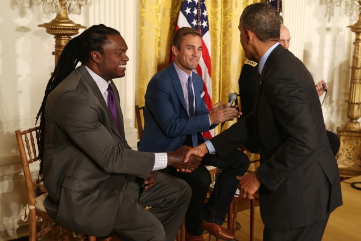 President Obama welcomed former NFL player LaVar Arrington and former pro soccer player Taylor Twellman to the White House on Thursday. (Chip Somodevilla/Getty Images)