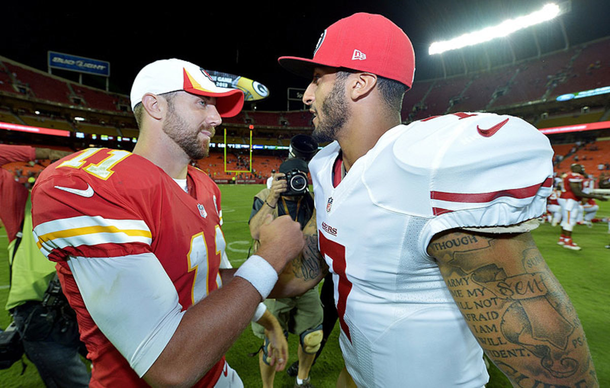 Alex Smith and Colin Kaepernick, here after a 2013 preseason game, were teammates on the 49ers in 2011-12. (John Sleezer/Getty Images)