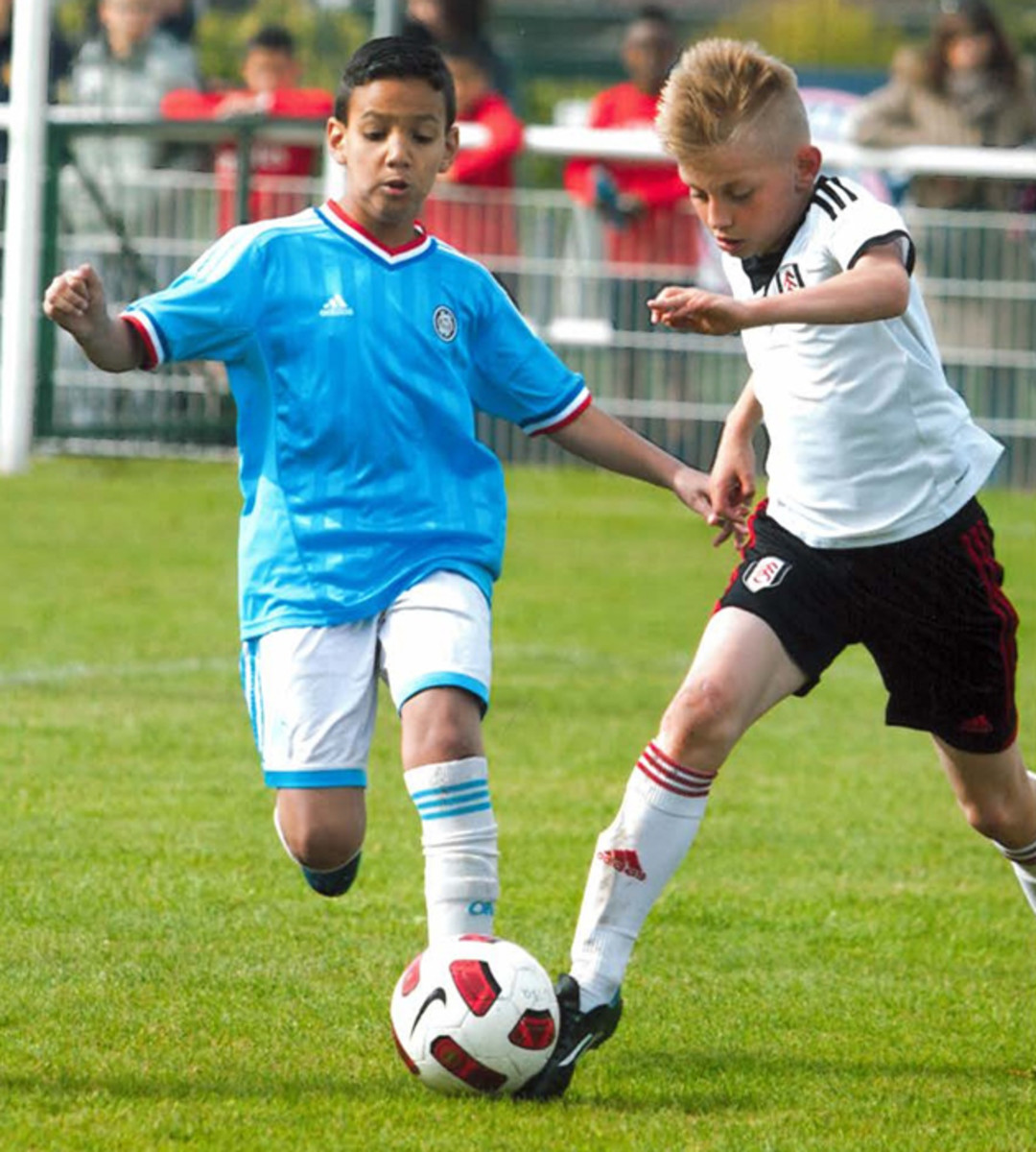 10-year-old Michael Moravek, right, gets an early start on his Fulham career.