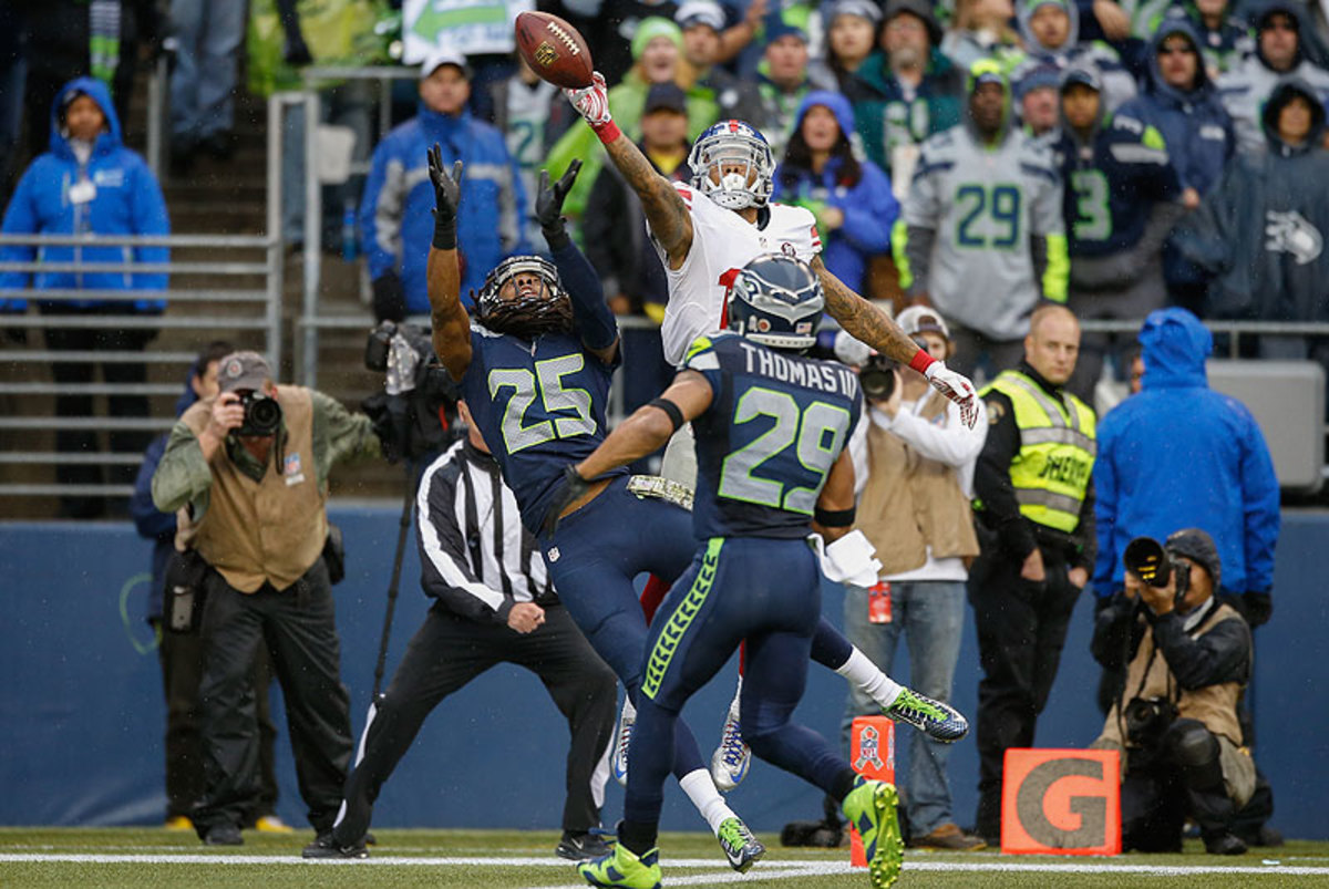 Richard Sherman's tip on a pass intended for Odel Beckham resulted in an Earl Thomas interception in the end zone. (Otto Greule Jr./Getty Images)