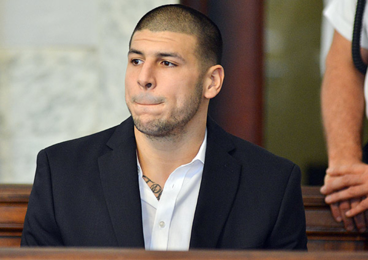 Aaron Hernandez (top) is currently awaiting trial on first-degree murder in the death of Odin Lloyd.