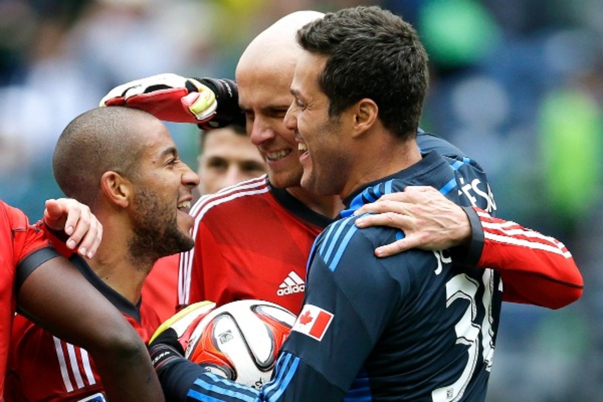 Goaltender Julio Cesar (right) celebrated a win Toronto FC teammates  in his MLS debut. (AP)