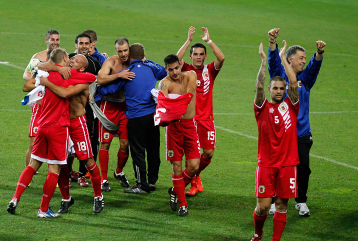 Gibraltar players celebrate after their first game as a member nation of UEFA, a 0-0 draw with Slovakia in Portugal in November 2013.