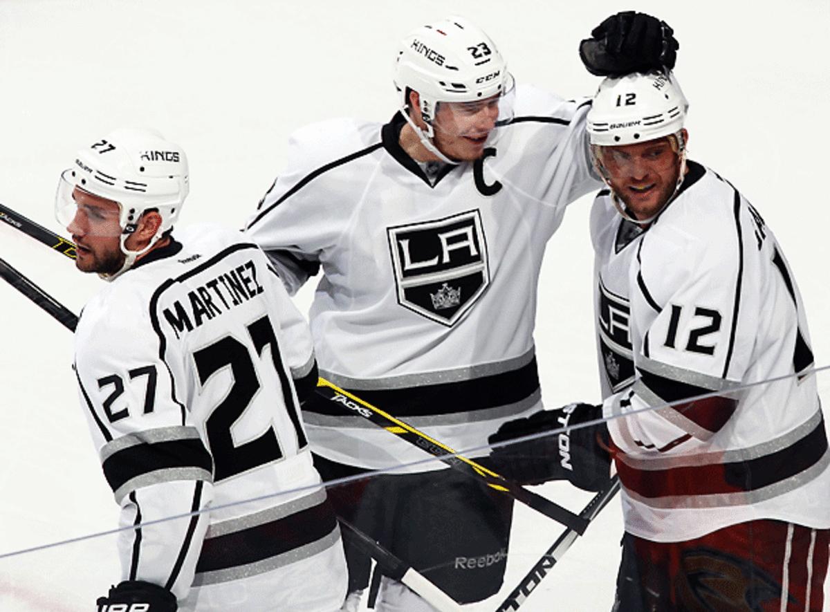 Marian Gaborik (12) gets congratulations from Dustin Brown (center) and Alec Martinez after his game-winning goal in Game 1.  (Debora Robinson/Getty Images)