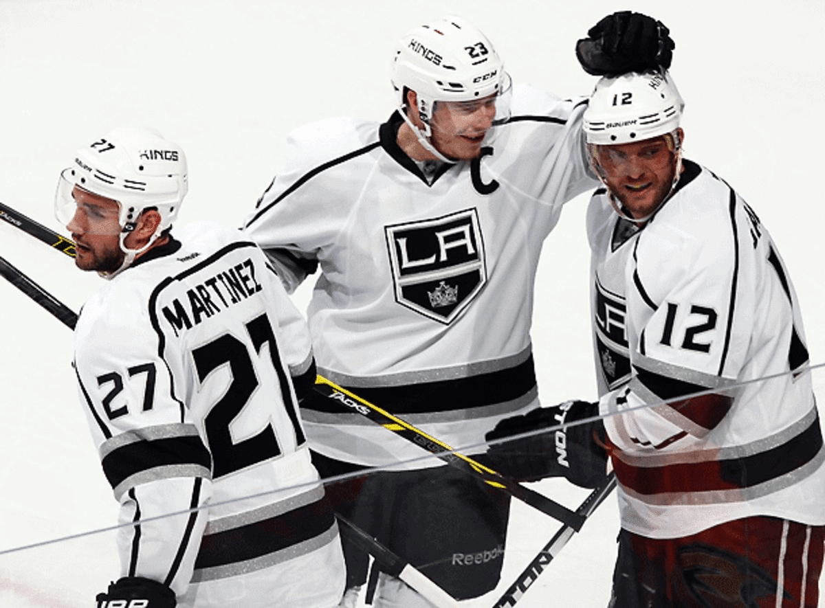 Marian Gaborik (12) gets congratulations from Dustin Brown (center) and Alec Martinez after his game-winning goal in Game 1. (Debora Robinson/Getty Images)