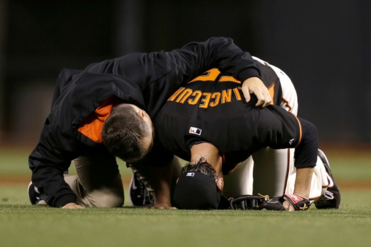 Tim Lincecum was in obvious pain after being hit by a comebacker on Friday night. (Jeff Chiu/Getty Images)