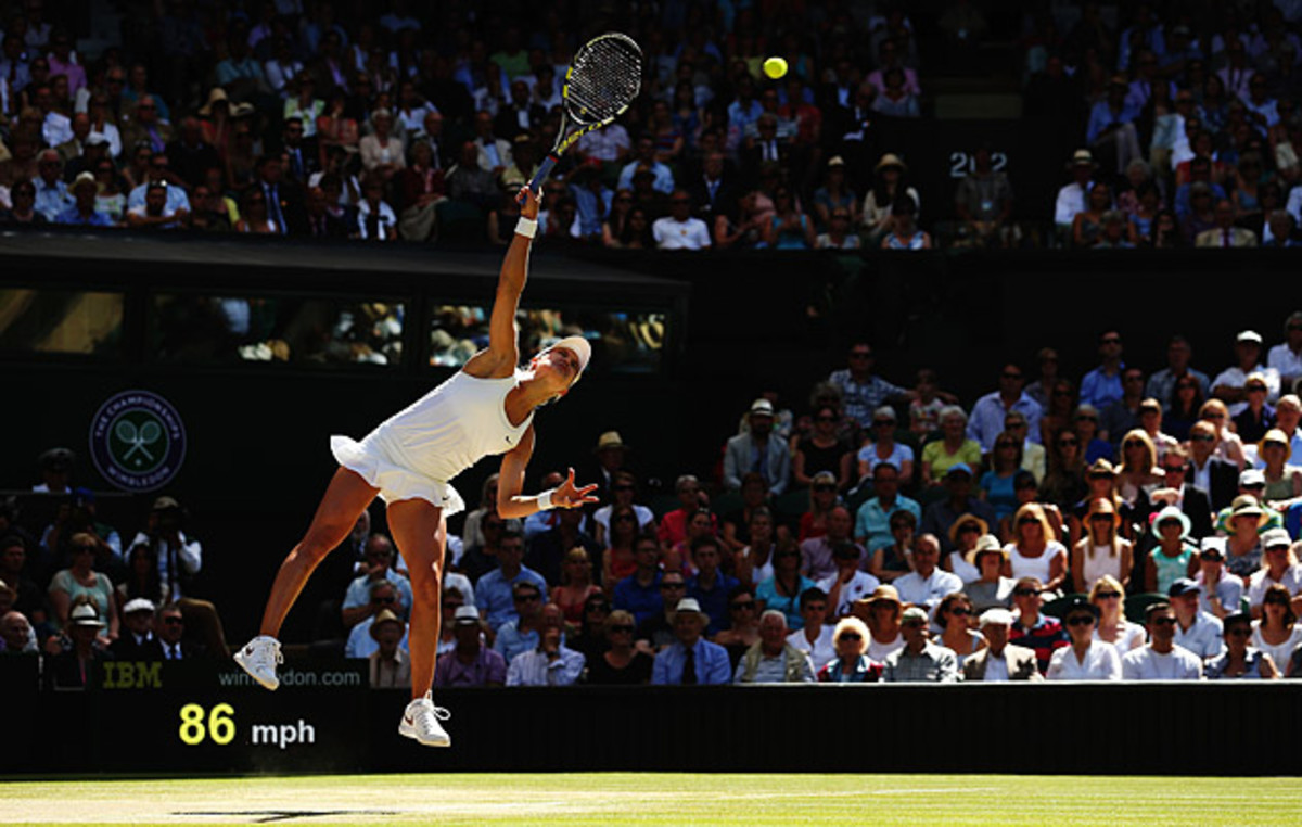 Eugenie Bouchard serves against Simona Halep in the Wimbledon semifinals.