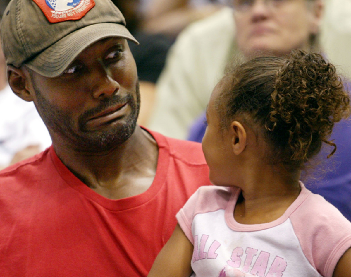 Malone jokes around with his daughter Karlee at a 2002 WNBA Game in Salt Lake City. (AP Photo/Steve C. Wilson)
