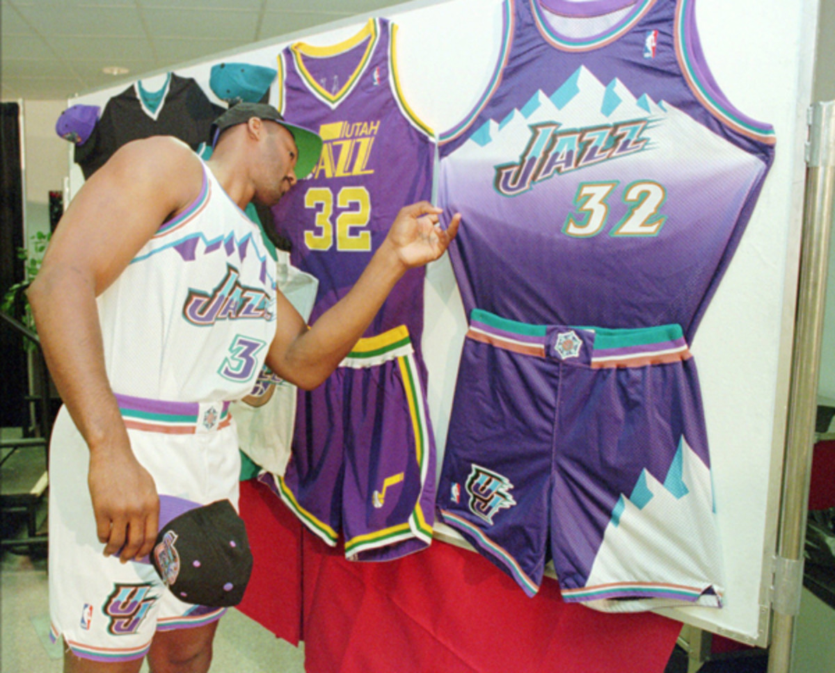 Malone helps unveil the new Utah Jazz logo in July 1996. (AP Photo/Steve C. Wilson)