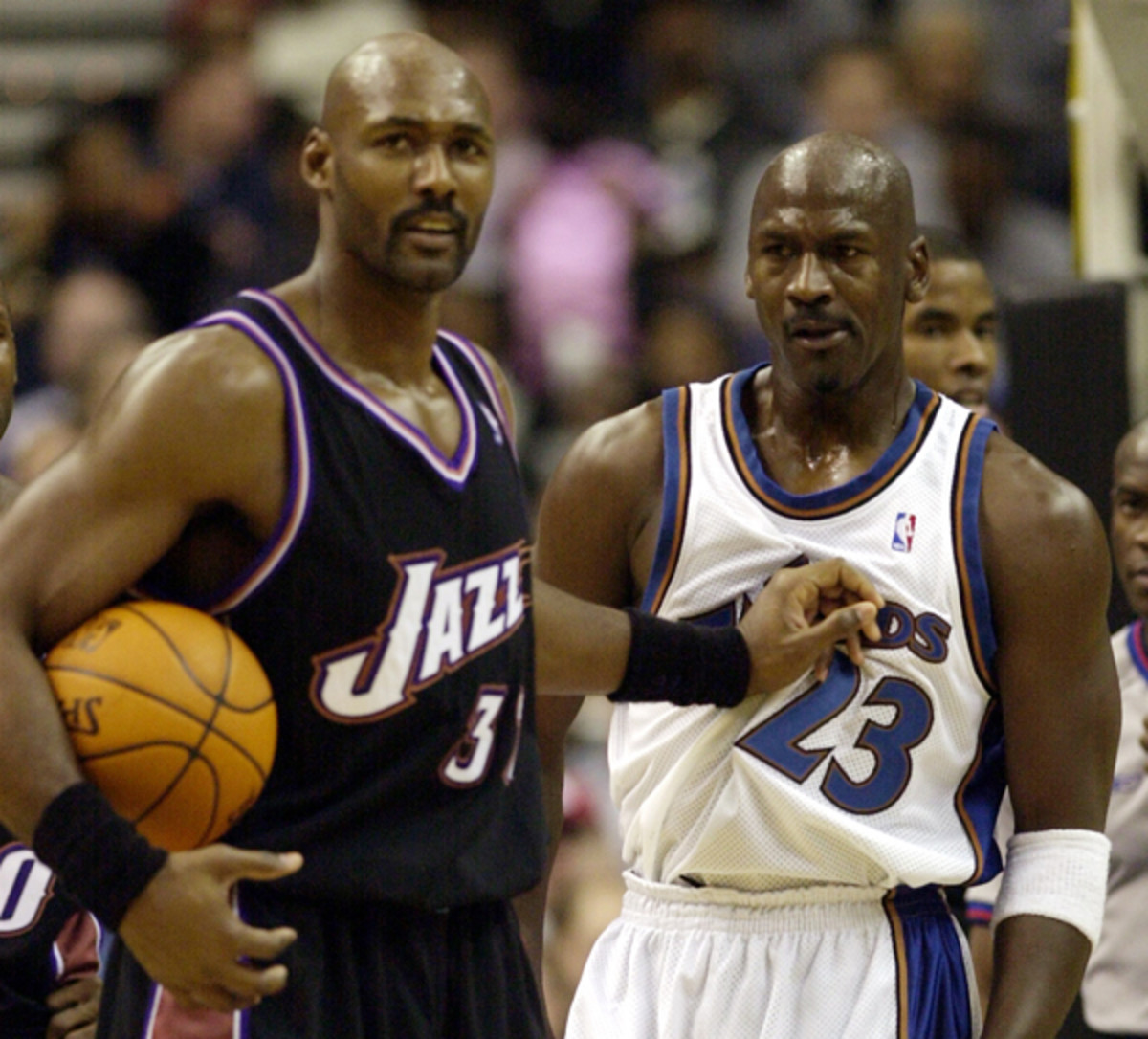 Longtime rivals Michael Jordan and Karl Malone exchange pleasantries before a 2002 Jazz-Wizards game. (AP Photo/Nick Wass)