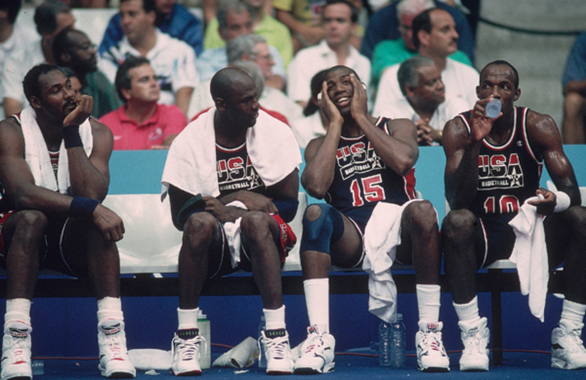 Malone joins Michael Jordan (9), Magic Johnson (15), and Clyde Drexler (10) on the bench during a 1992 Olympics game against game Puerto Rico. (John W. McDonough/SI)