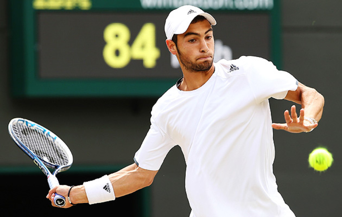 Noah Rubin returns a shot to Stefan Kozlov during the Wimbledon Boys' singles final.