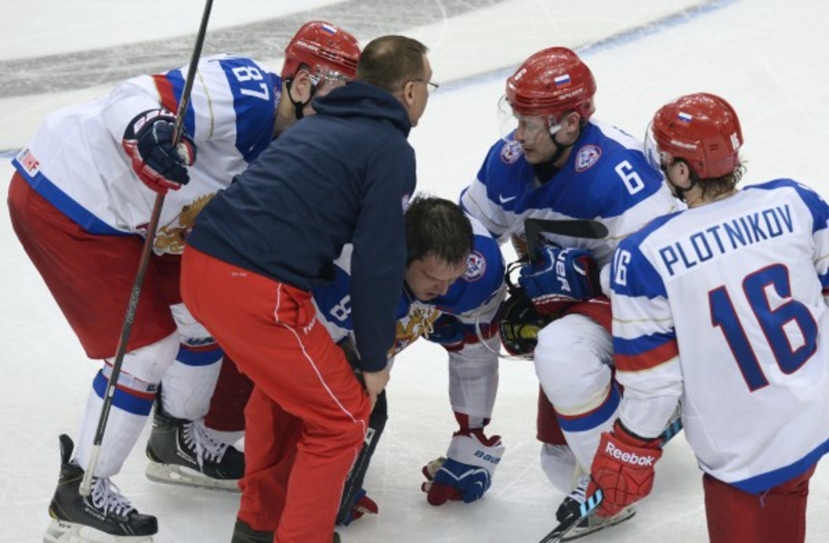 Alex Ovechkin was taken out by an open-ice hip check that hit him on the left knee. (Alexander Nemenov/Getty Images)