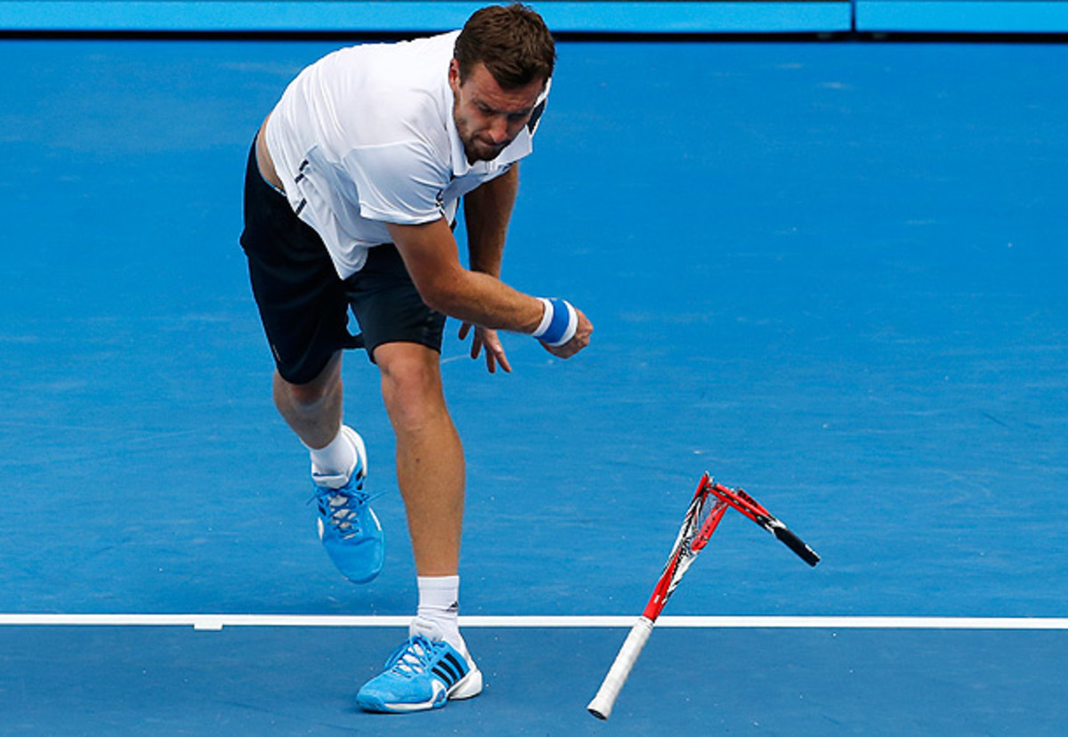 Ernests Gulbis smashes his racket during his second-round match against Sam Querrey at the Australian Open. (Eugene Hoshiko/AP)