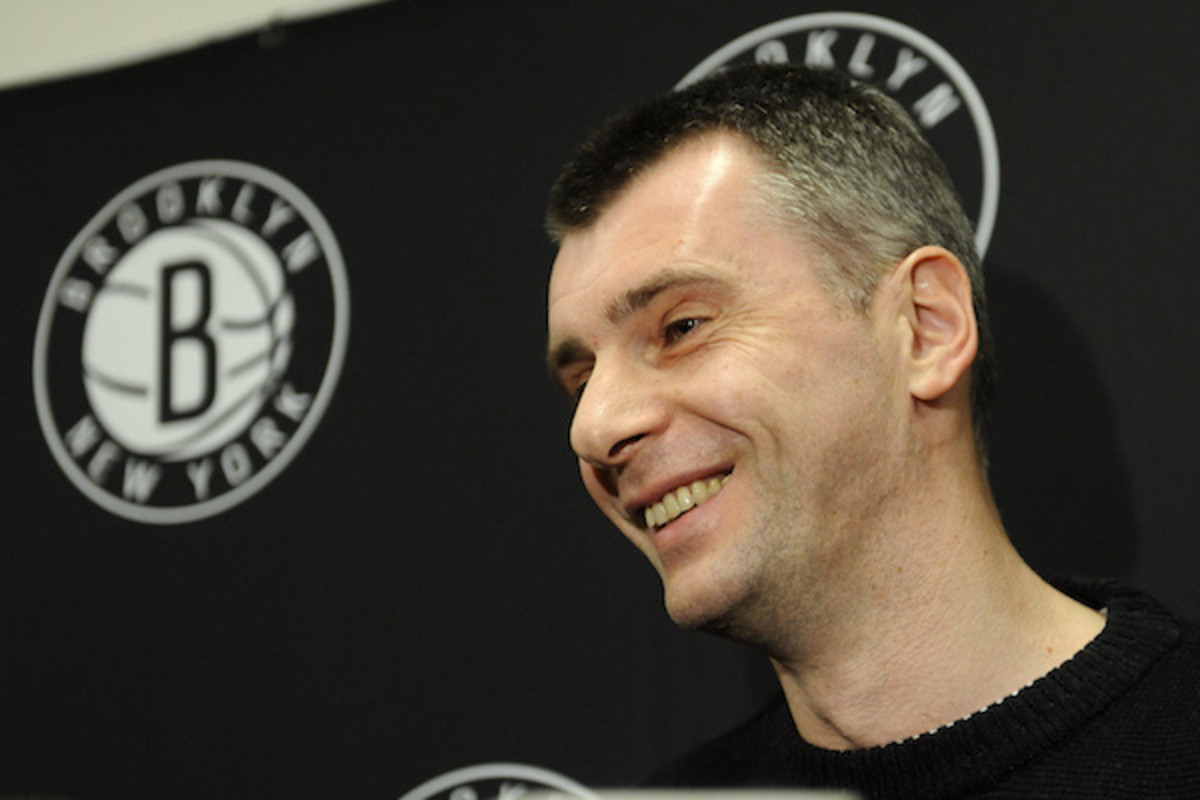 Prokhorov speaks to press during a Nets game in 2012 (Kathy Kmonicek/AP)