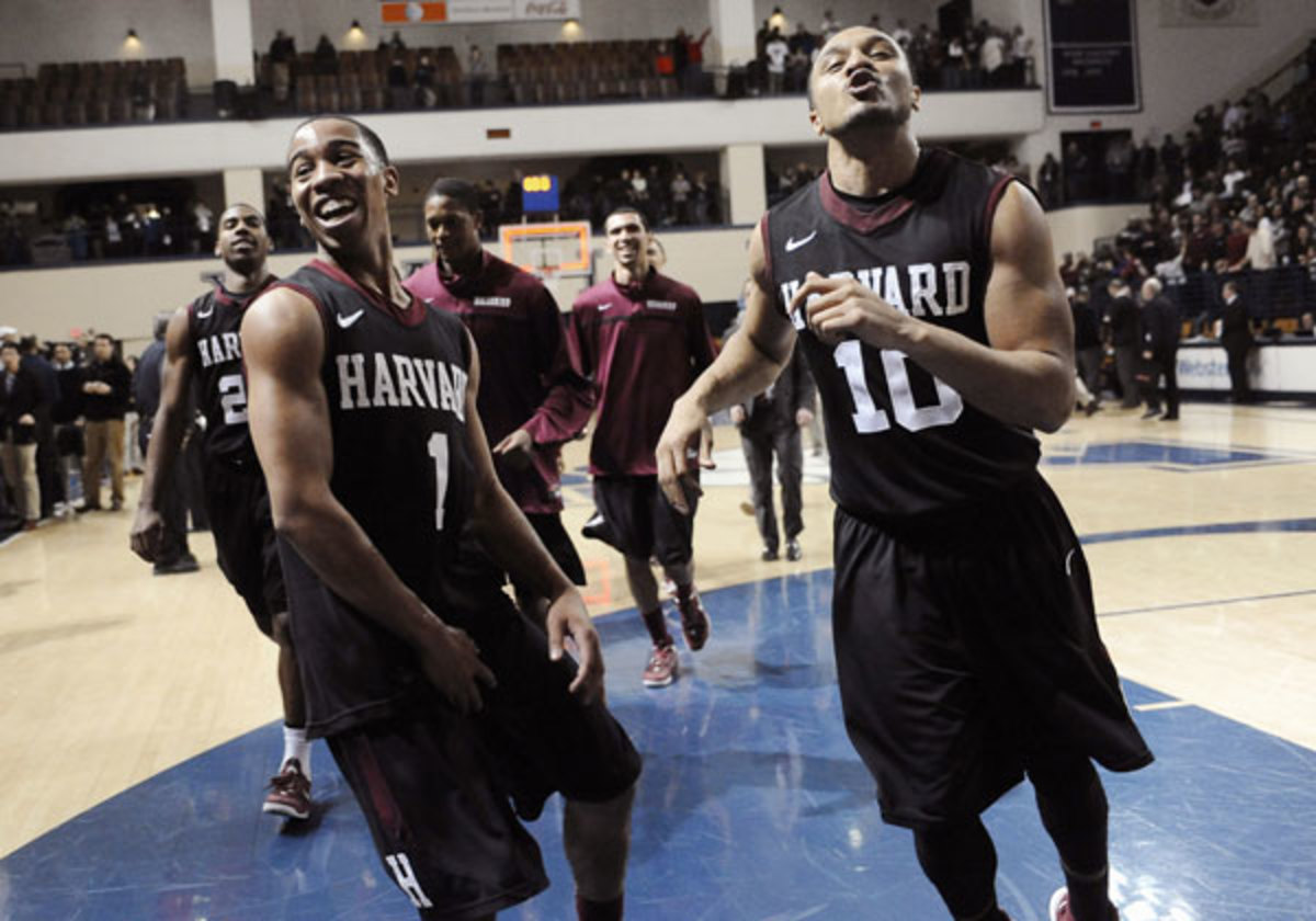 Harvard's Siyani Chambers, left, and Brandyn Curry celebrate Harvard earning the first bid to the 2014 NCAA tournament. (Jessica Hill/AP)