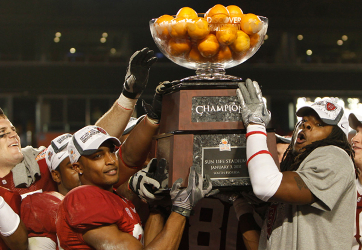 Dougt Baldwin (l.) and Richard Sherman hoist the 2011 Orange Bowl trophy after Stanford beat Virginia Tech, 40-1. (J Pat Carter/AP)