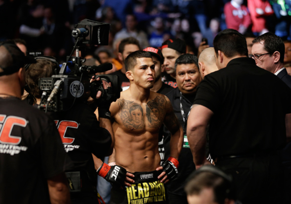 Anthony Pettis checks before fighting with Donald Cerrone during UFC Lightweight Championship on FOX 6 at the United Center in Chicago, Saturday, Jan. 26, 2013. Pettis won the bout.
