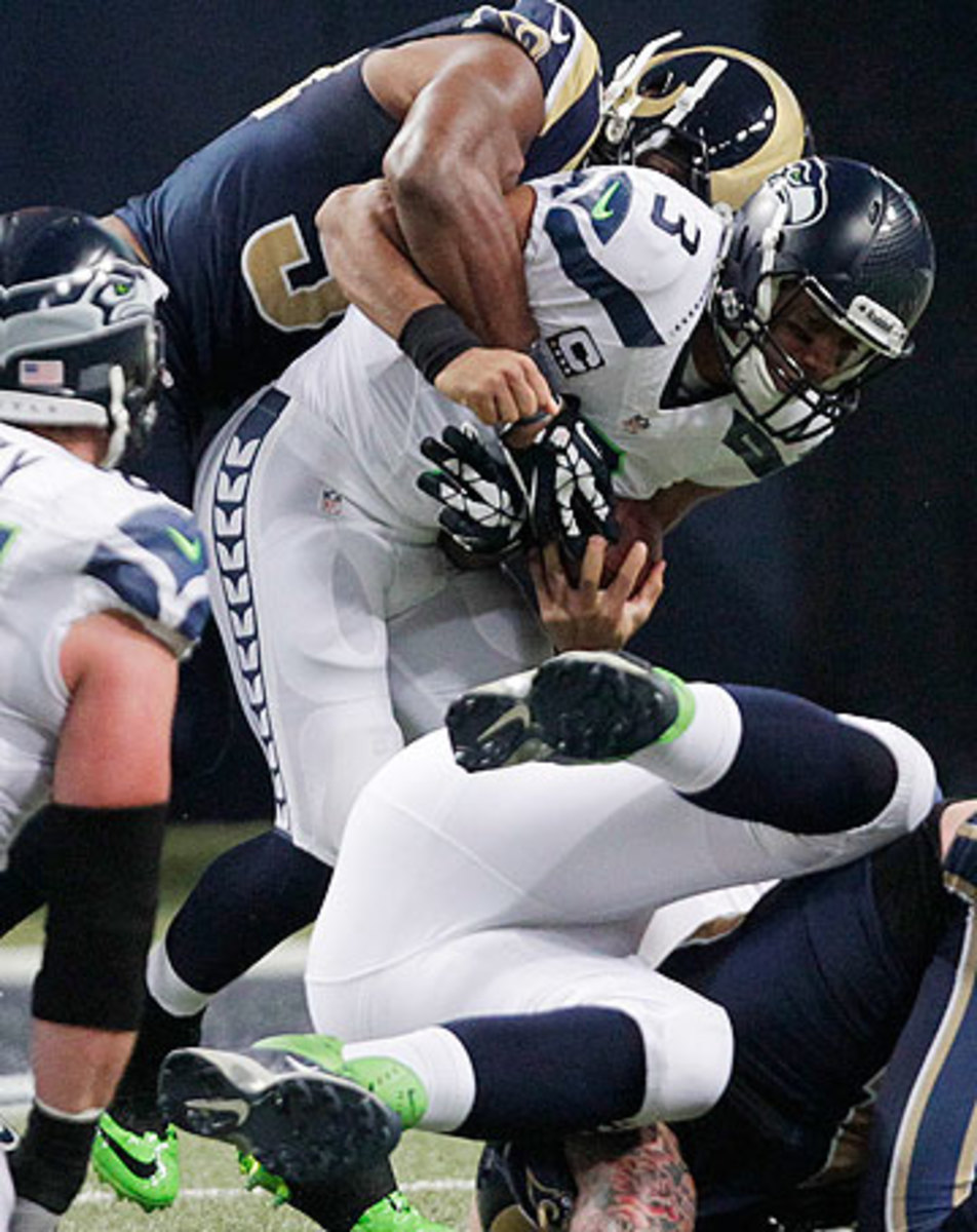 Protecting Russell Wilson could be an issue for the Seahawks this season. (Tom Ganam/AP)