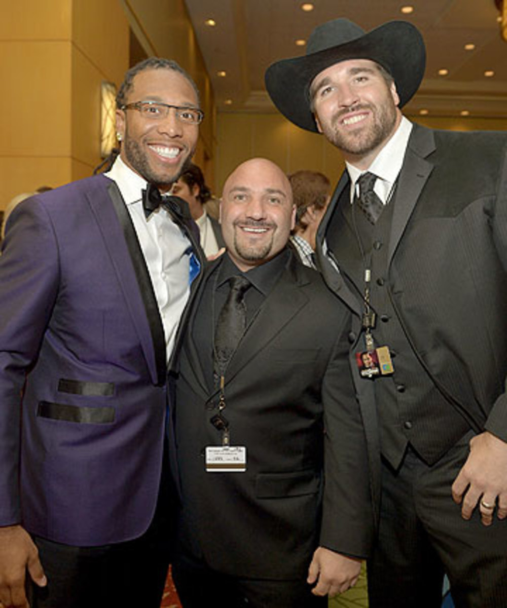 Jay Glazer, here with Larry Fitzgerald (left) and Jared Allen, does not apologize for having friendships with the athletes he covers. (Charley Gallay/Getty Images)