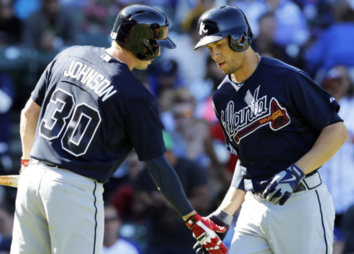 Chris Johnson and Andrelton Simmons celebrate during the Braves' game against the Cubs.