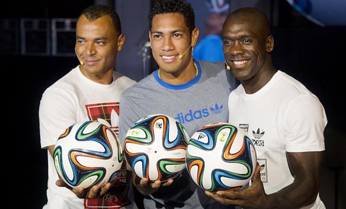 Former Brazilian star Cafu, Hernanes, and Clarence Seedorf present the new ball that will be used in next year's World Cup. 