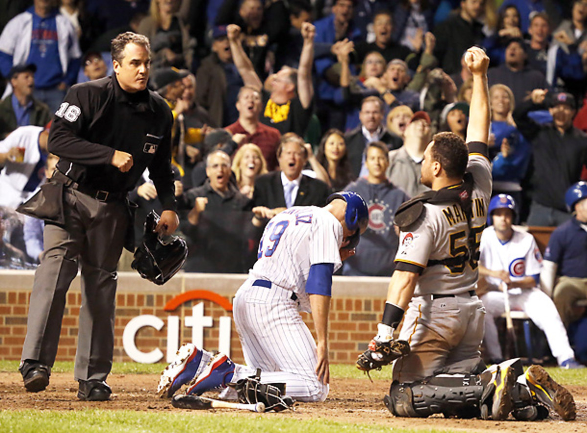 The Pirates' Russell Martin triumphantly raises up the ball after recording the final out of Monday's win. (AP)