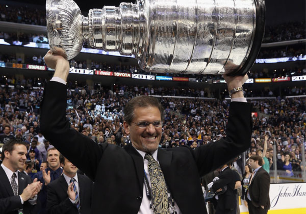 Ron Hextall hoists the Los Angeles Kings' Stanley Cup after their 2012 title. (Bruce Bennett/Getty Images)