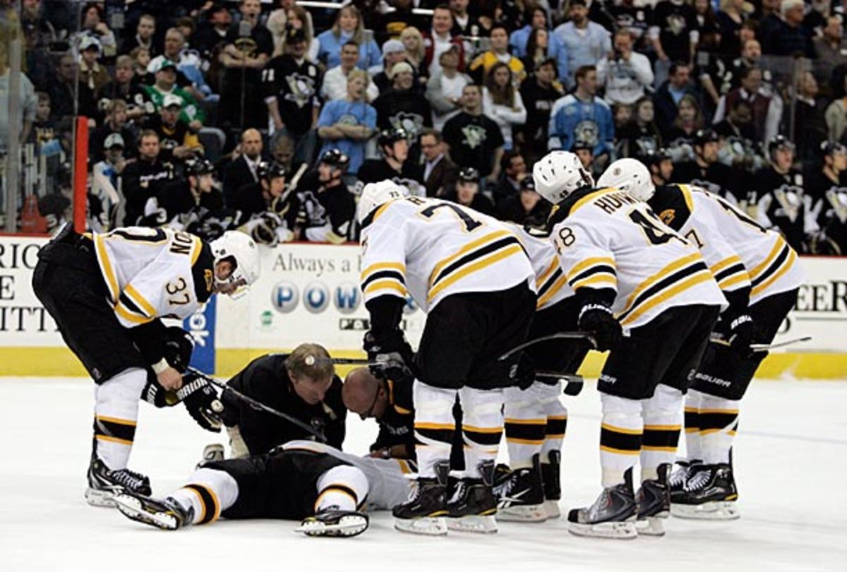 Marc Savard of the Boston Bruins lies on the ice after suffering a concussion.